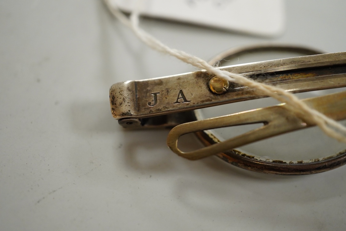 A pair of American ‘coin’ silver spectacles, first half 19th century by McAllister, Philadelphia, with slider sides, stamped inside McALLISTER PHILAD- and to the exterior hinge ‘JA 13’, unmarked leather and card case